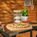 Fertige neapolitanische Pizza auf OONI Bambus-Pizzaschieber – Margherita mit Basilikum auf OONI Klapptisch